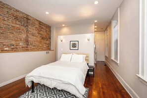 The loft sleeping area boasts a plush queen bed, ensuite, & laundry access