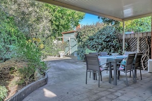 Relax in the spacious undercover patio, perfect for alfresco dining and surrounded by lush greenery.
