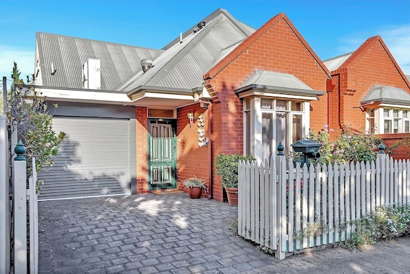 This charming North Adelaide home features a private driveway for easy parking and a welcoming front entrance.
