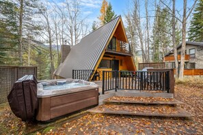 Backyard with outdoor seating and a private hot tub.