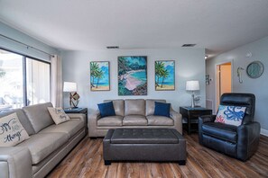 Bright living space with sofa sleeper, and Smart TV