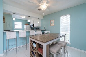 Gather for meals together at the dining table, offering seating for 4