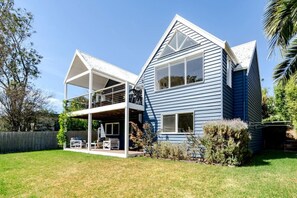 Two outdoor living spaces overlook the rear yard
