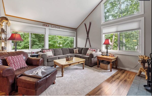 Beautiful family room with vaulted ceilings and wood burning fireplace. 
