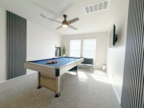 Game room with a pool table and 4K TV
