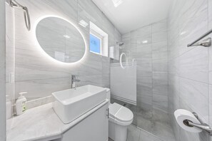 Start or end your day in our well-stocked bathroom with a refreshing walk-in shower, vanity, and all essentials provided. An ideal space to unwind after beach-filled days.