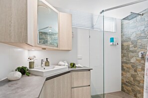 Modern bathroom with body wash, conditioner and shampoo