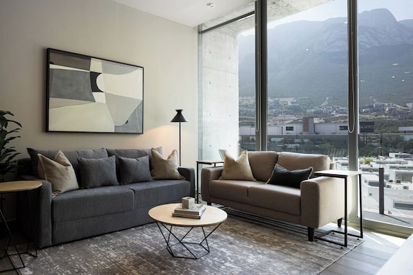 Cozy living room with floor-to-ceiling windows and stunning mountain views. 