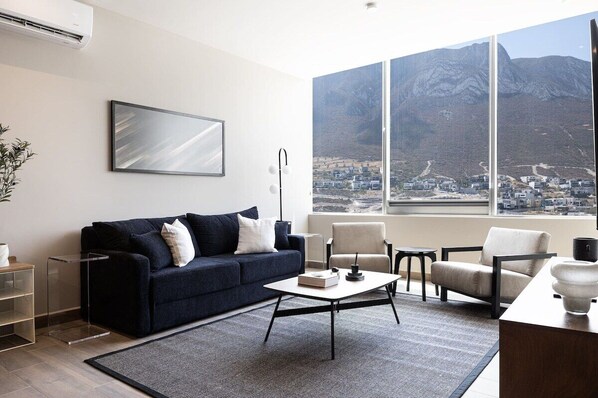 Spacious living room with huge windows, offering breathtaking mountain views.