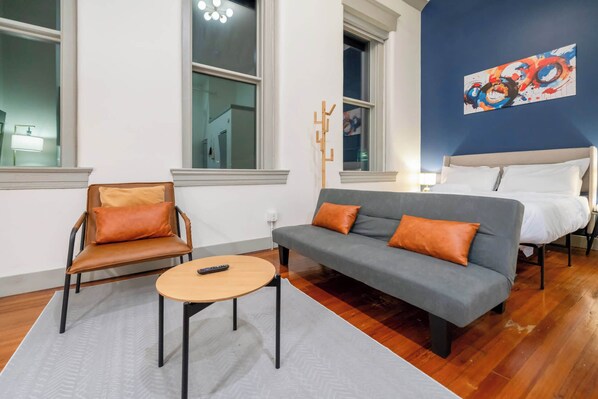 Living Room: Stylish living space with bold accent walls and ample natural light, creating an inviting atmosphere for any occasion.