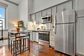 Spacious kitchen with updated cabinetry and modern appliances, perfect for preparing meals. 