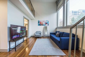 Make yourself at home in the cozy living room with a comfy sofa and TV to unwind.