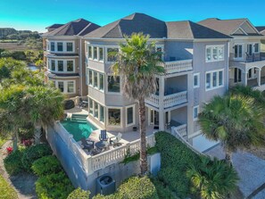 Step inside this stunning 7-bedroom vacation home, just steps from the beach, offering plenty of space for family and friends. The bright, open-concept living area invites relaxation, with the modern decor and comfortable furnishings
