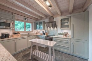 Large, modern kitchen fully equipped with all amenities and two separate ovens.