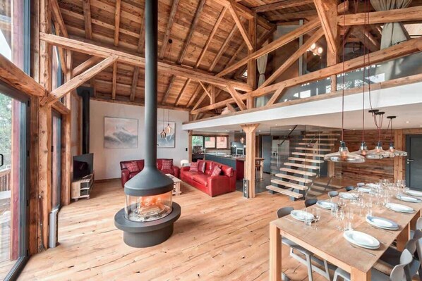 Stunning open plan living area with bi-folding doors on two sides and views looking out over the valley and ski slopes.