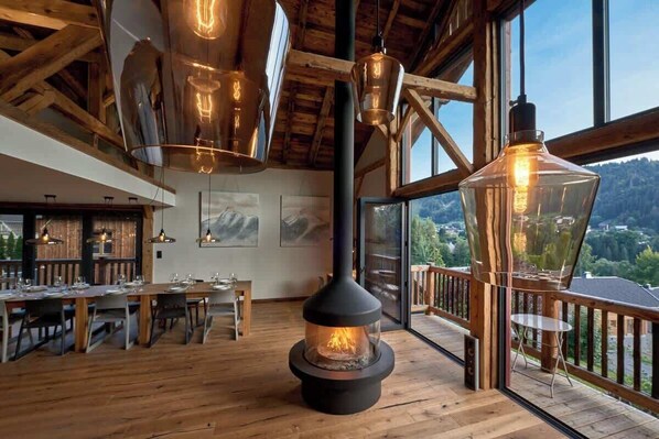 Stunning open plan living area with bi-folding doors on two sides and views looking out over the valley and ski slopes.