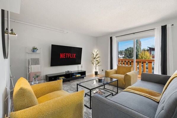 Relax in the spacious living room featuring a Futon Sofa Bed with linens provided, a smart TV with Netflix, and a variety of board games for your entertainment.