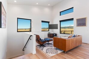 Enjoy relaxing in the elevated living space, equipped with new leather furniture and a smart TV. 