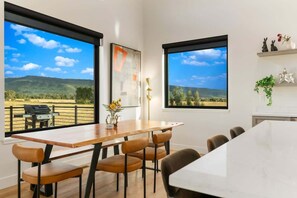 The well-lit dining area takes advantage of huge windows for fantastic views of the Teton mountain range.