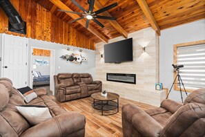 Living Room facing Bedroom 3: Fireplace, 65" TV, Roku, books, & spotting scope