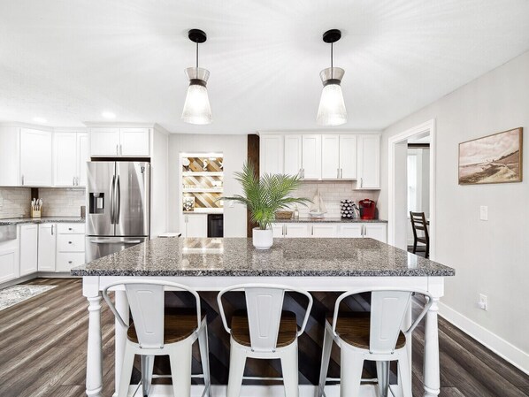✨ Whip up your favorite meals in this stunning, fully stocked kitchen featuring granite countertops, stainless steel appliances, and a spacious island perfect for gathering!