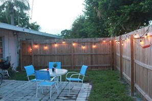 Unwind in your private, fenced-in backyard oasis. String lights included.