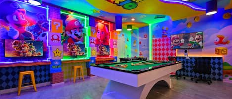 Jump into the ultimate Super Mario game room with arcades, pool, and bold colors!
