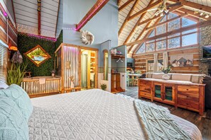 This cozy cabin bedroom offers a king bed, warm wood accents, and natural light.