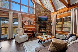 Relax in comfort with cozy seating, a flat-screen TV, and scenic views.