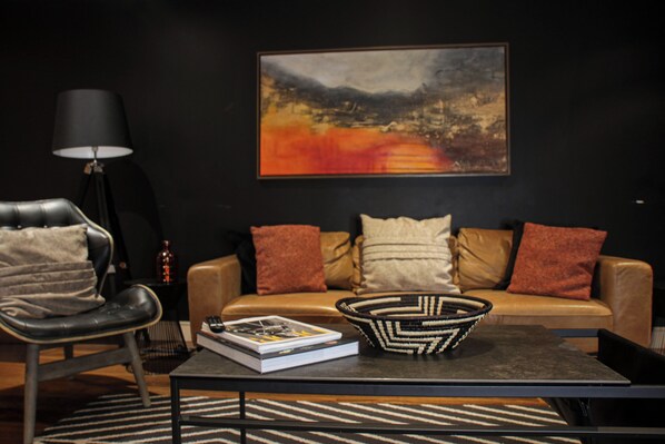 Spacious open-plan living room with kitchen, air-conditioning and balcony access