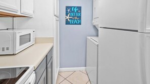 The full kitchen has everything you need to whip up family meals--plus a tucked-away washer + dryer to keep your clothes fresh!