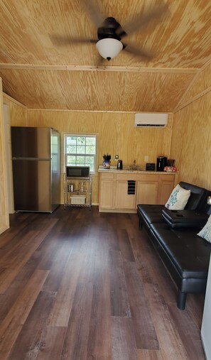 Full size fridge and microwave with dishes