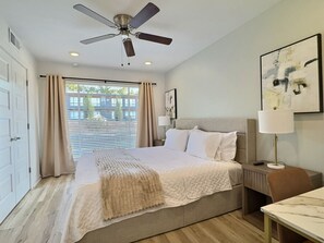 Experience ultimate relaxation in this beautifully styled bedroom with a plush bed covered in comfy linens and a soft throw.