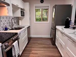 Kitchen with a window overlooking a quiet side street. 