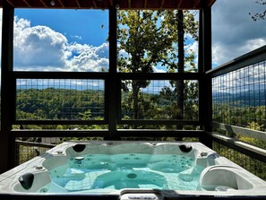 Soak in a large hot tub while enjoying breathtaking mountain views.