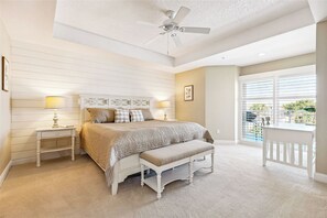 Step into the master bedroom with a king-size bed, where plush bedding and soft lighting promise a peaceful night's sleep.