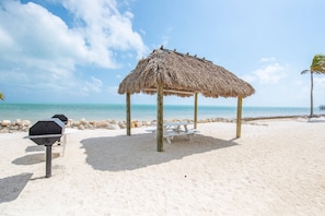Enjoy a delicious meal under the tiki hut while taking in the breathtaking ocean views and the soothing sounds of the waves.