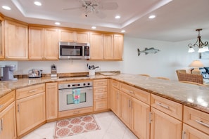 The updated kitchen features stainless steel appliances & granite countertops, combining style & functionality for a perfect cooking experience.