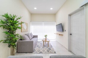 Relax in the cozy living room, featuring comfortable seating and a warm, welcoming atmosphere