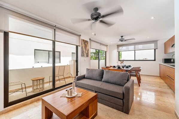 Relax in the cozy living room, featuring comfortable seating and a warm, welcoming atmosphere