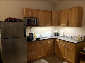 Kitchen with full-size fridge, microwave, stove, toaster, oven, Nespresso coffee