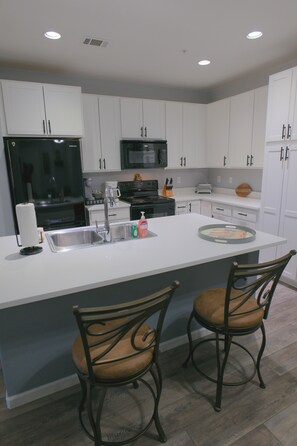 Fully equipped kitchen with spacious island for gathering.