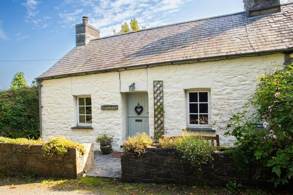 White wash stone cottage with blue stable door