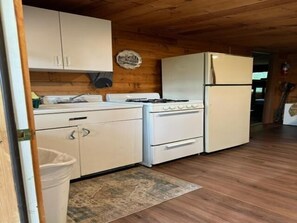 Kitchen with cookware, silverware and dinnerware