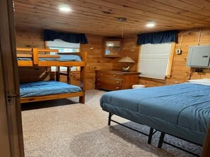 Bedroom with double bed and twin bunk beds