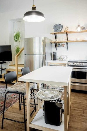 The kitchen island and 2 barstools make this the perfect dining area for this small but gorgeous space!