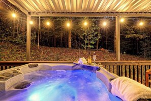Nestled in the heart of the woods, this secluded retreat offers complete privacy with no neighbors in sight. The beautifully lit property allows you to enjoy the hot tub and peaceful creek at any time of day or night.