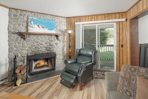 Stone fireplace with cozy seating.