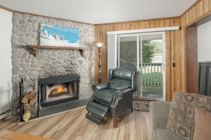 Stone fireplace with cozy seating.