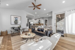 Offers leather sofa seating, accent chairs and a gas fireplace and opens to the kitchen area